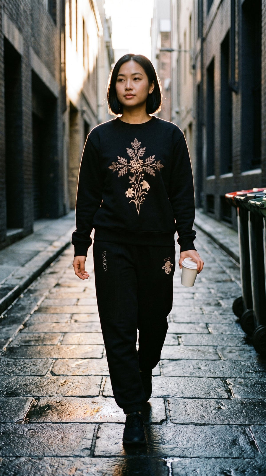 Consider The Lilies black crewneck and jogger set worn walking a dawn laneway