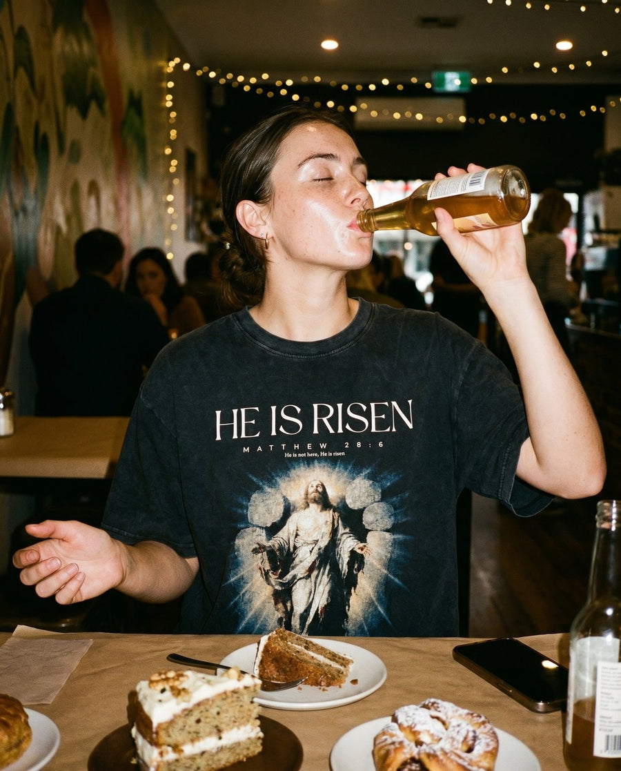Model wearing the NaskiCo He Is Risen Christian streetwear tee