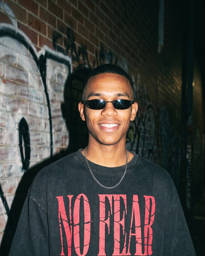 Kai wearing the NaskiCo No Fear Christian streetwear tee, Romans 8:37